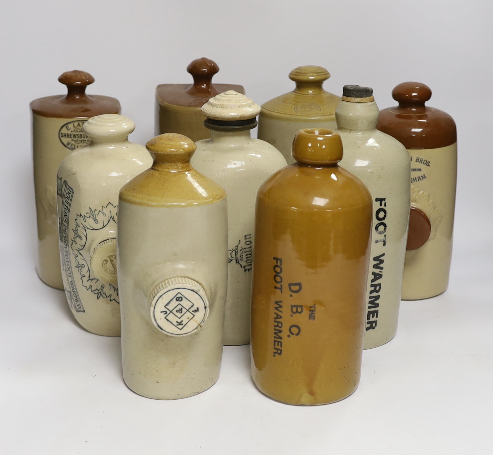 Nine stoneware hot water bottles, early 20th century, largest 25cm high